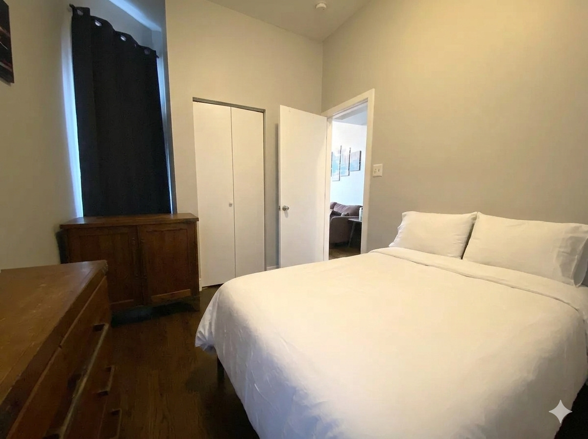 2129 North Racine Avenue, Unit 2 Chicago, IL 60614 - Photo 9 of 11 a bedroom with a bed and a dresser