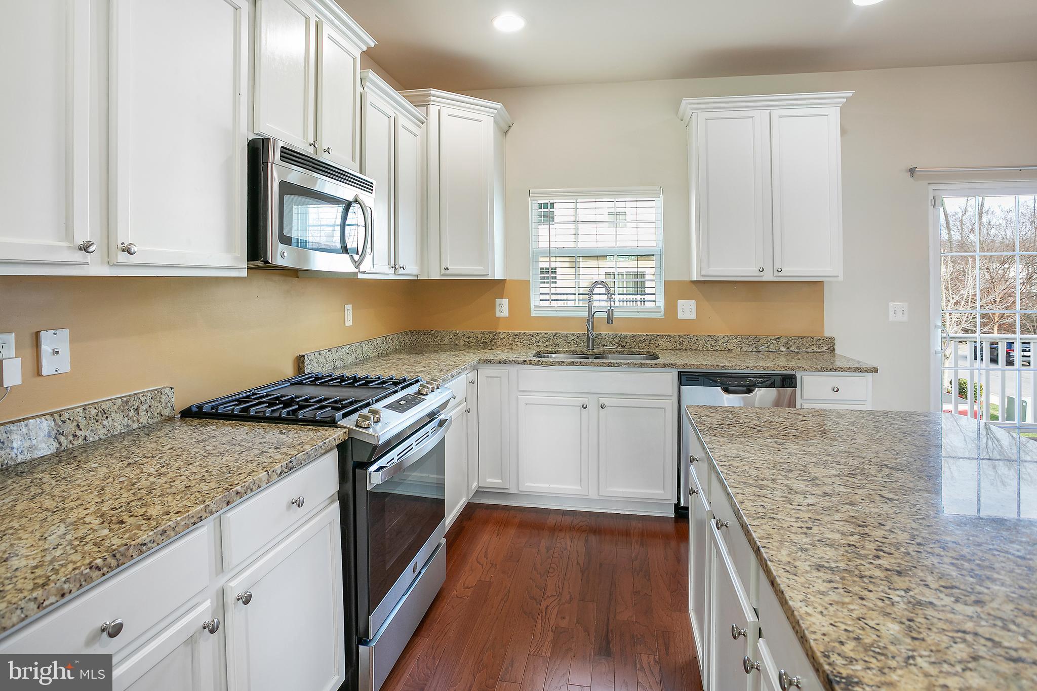 2885 Falkirk Alley Bryans Road, MD 20616 - Photo 12 of 43 a kitchen with stainless steel appliances granite countertop a stove a sink and a white cabinets