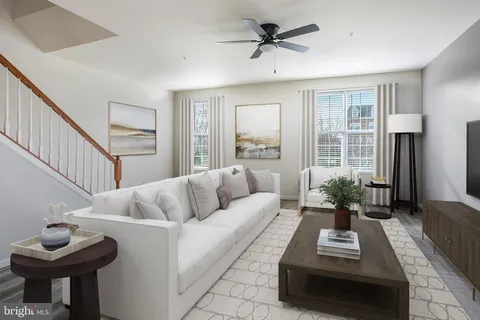 a living room with furniture and a potted plant