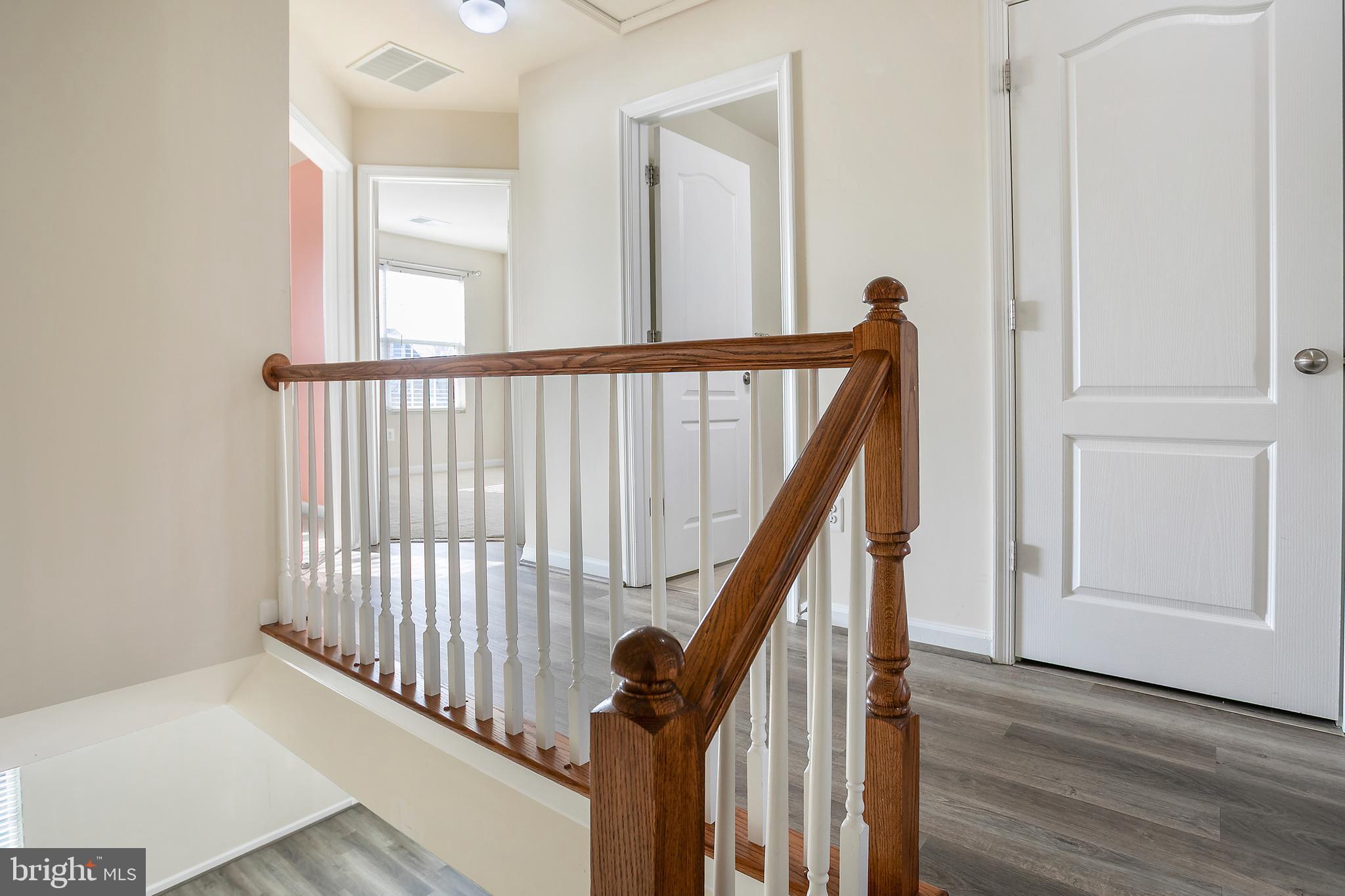 2885 Falkirk Alley Bryans Road, MD 20616 - Photo 21 of 43 a view of a hallway with wooden floor and staircase