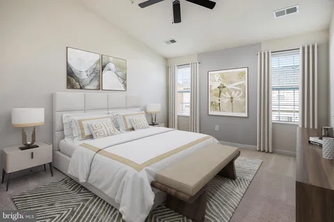 a bedroom with a large bed a lamp and a window