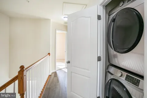 a view of a hallway with washer and dryer