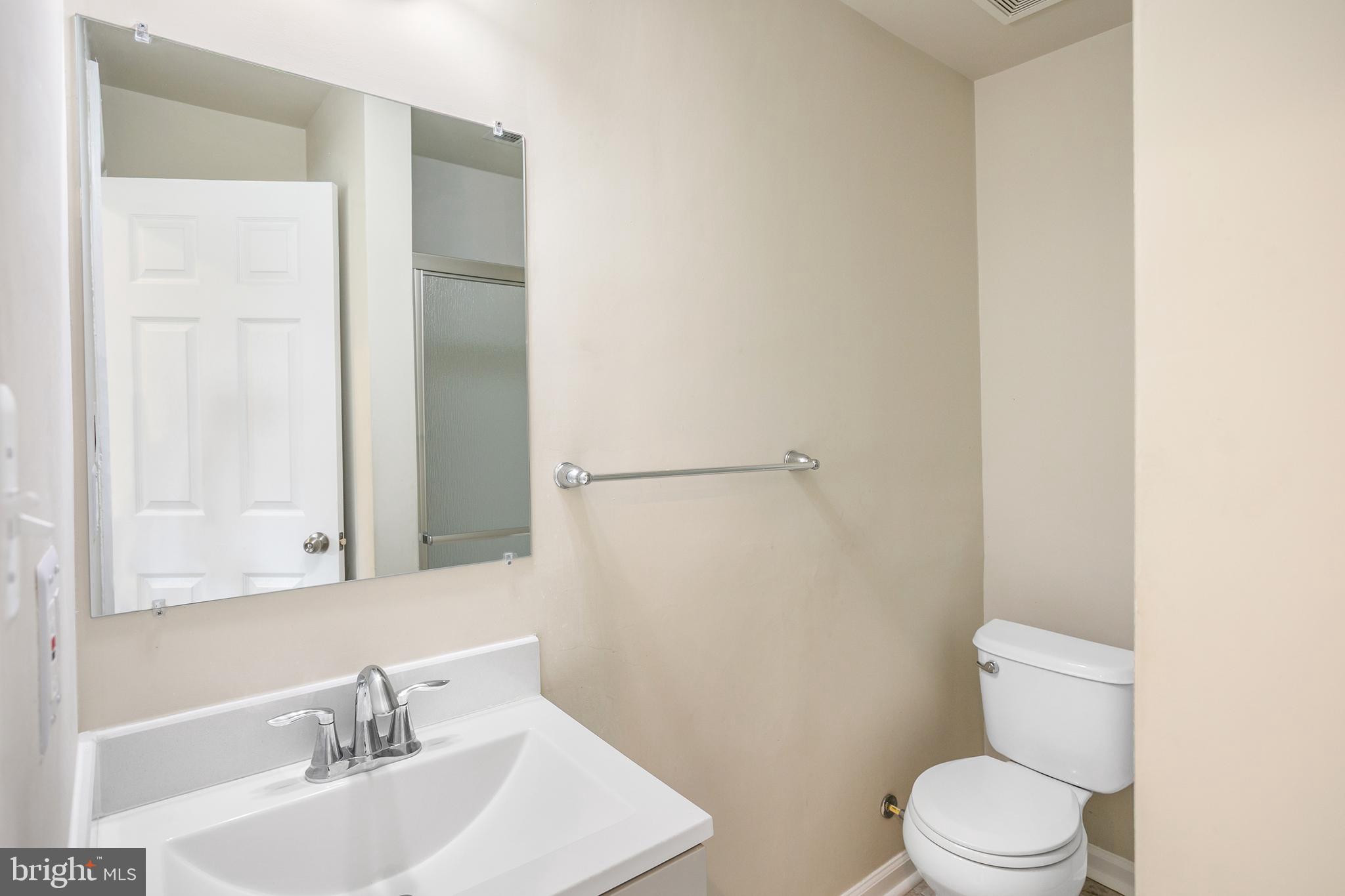 2885 Falkirk Alley Bryans Road, MD 20616 - Photo 5 of 43 a bathroom with a sink a toilet and a mirror