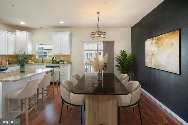 a view of a dining room with furniture window and wooden floor