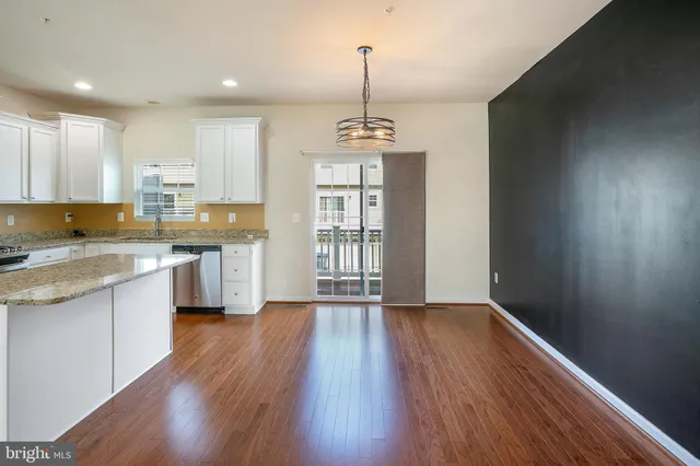 a view of kitchen with wooden floor and window