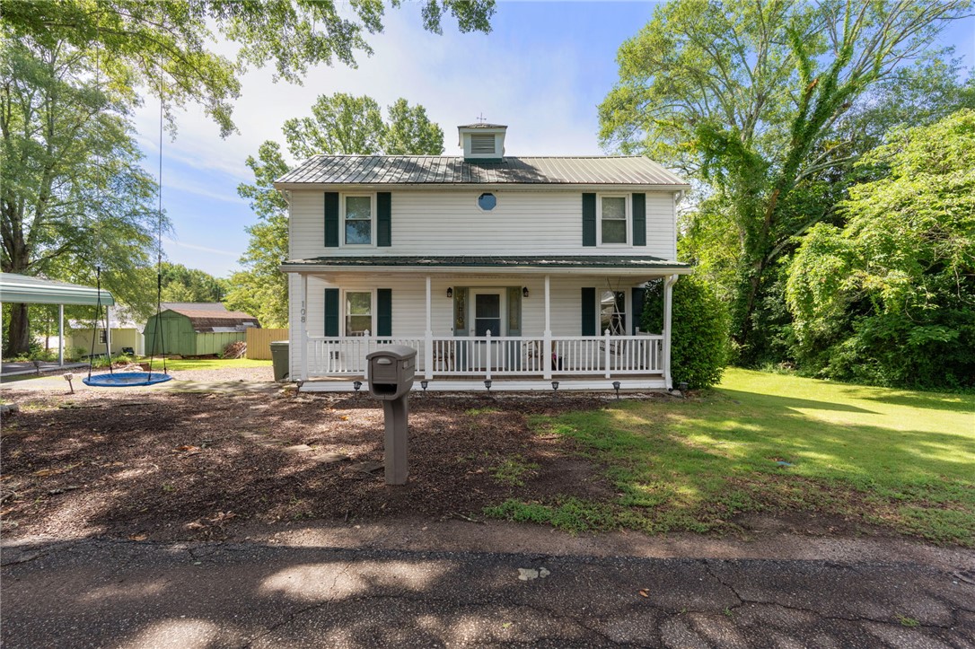 108 Tarrant Street Central, SC 29630 - Photo 1 of 42 A classic two-story residence with a welcoming front porch set amidst mature trees and a verdant yard.