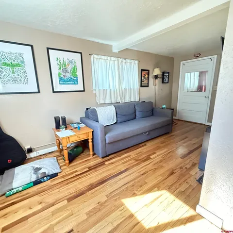 a picture of a room that has a rug and a white wall