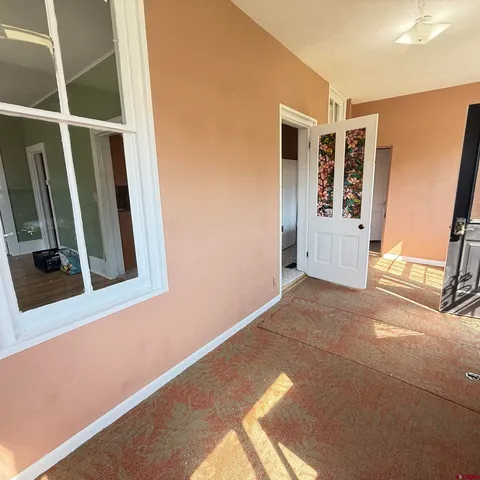 a kitchen with refrigerator and cabinets