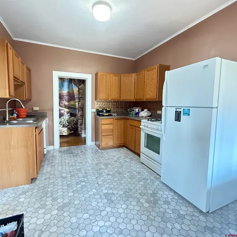 a backyard of a house with table and chairs