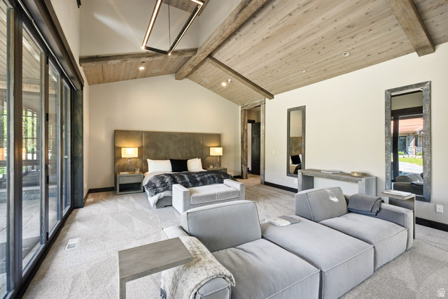 1575 Old Ranch Road Park City, UT 84098 - Photo 19 of 45 Vaulted wood plank ceiling with exposed beams, large format sliding glass doors, contemporary linear chandelier, and built-in mirror accents