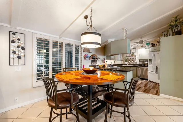 a dining room with furniture window and wooden floor