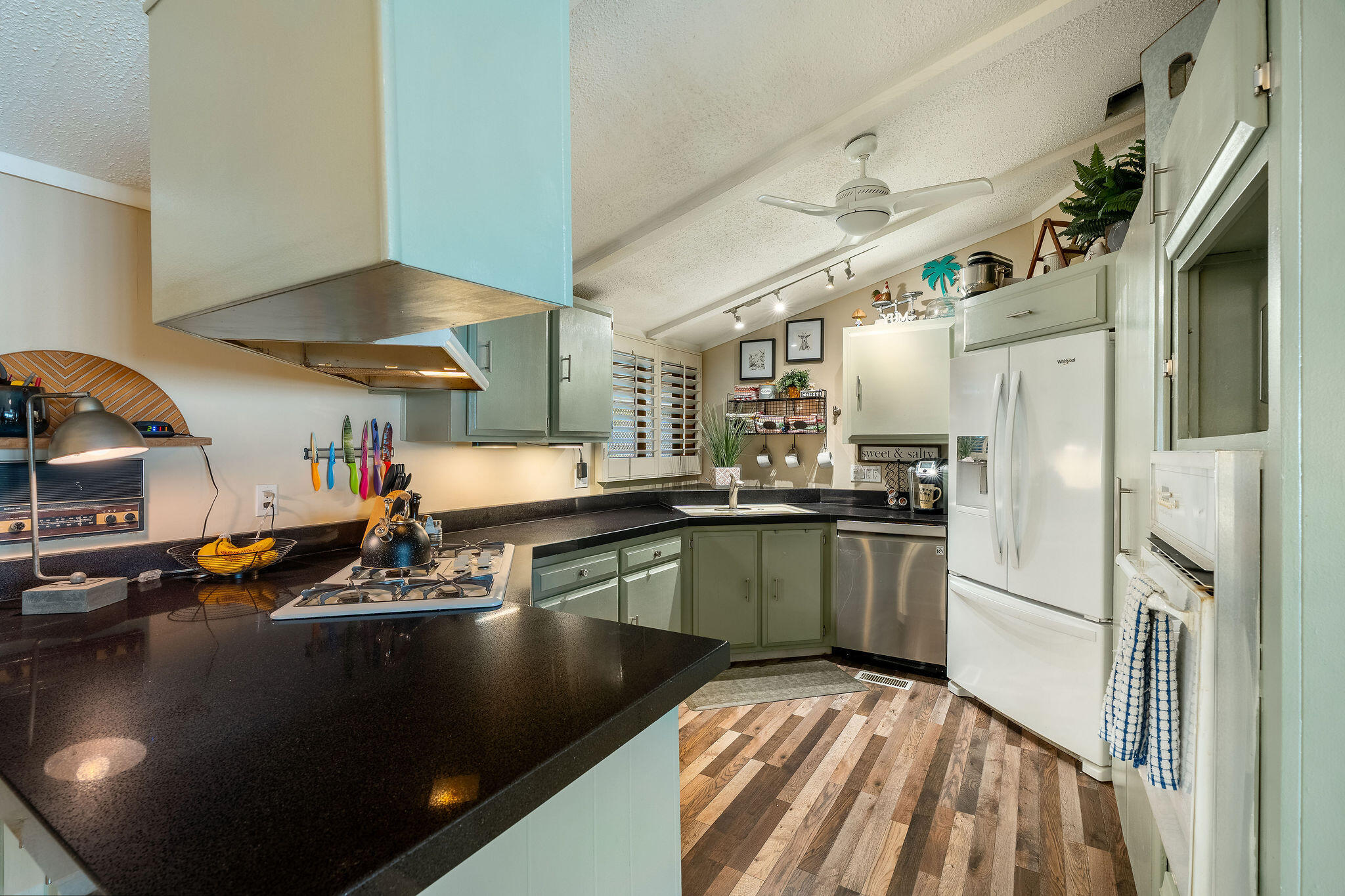 109 International Boulevard Rancho Mirage, CA 92270 - Photo 18 of 64 a kitchen with stainless steel appliances granite countertop a sink refrigerator and stove
