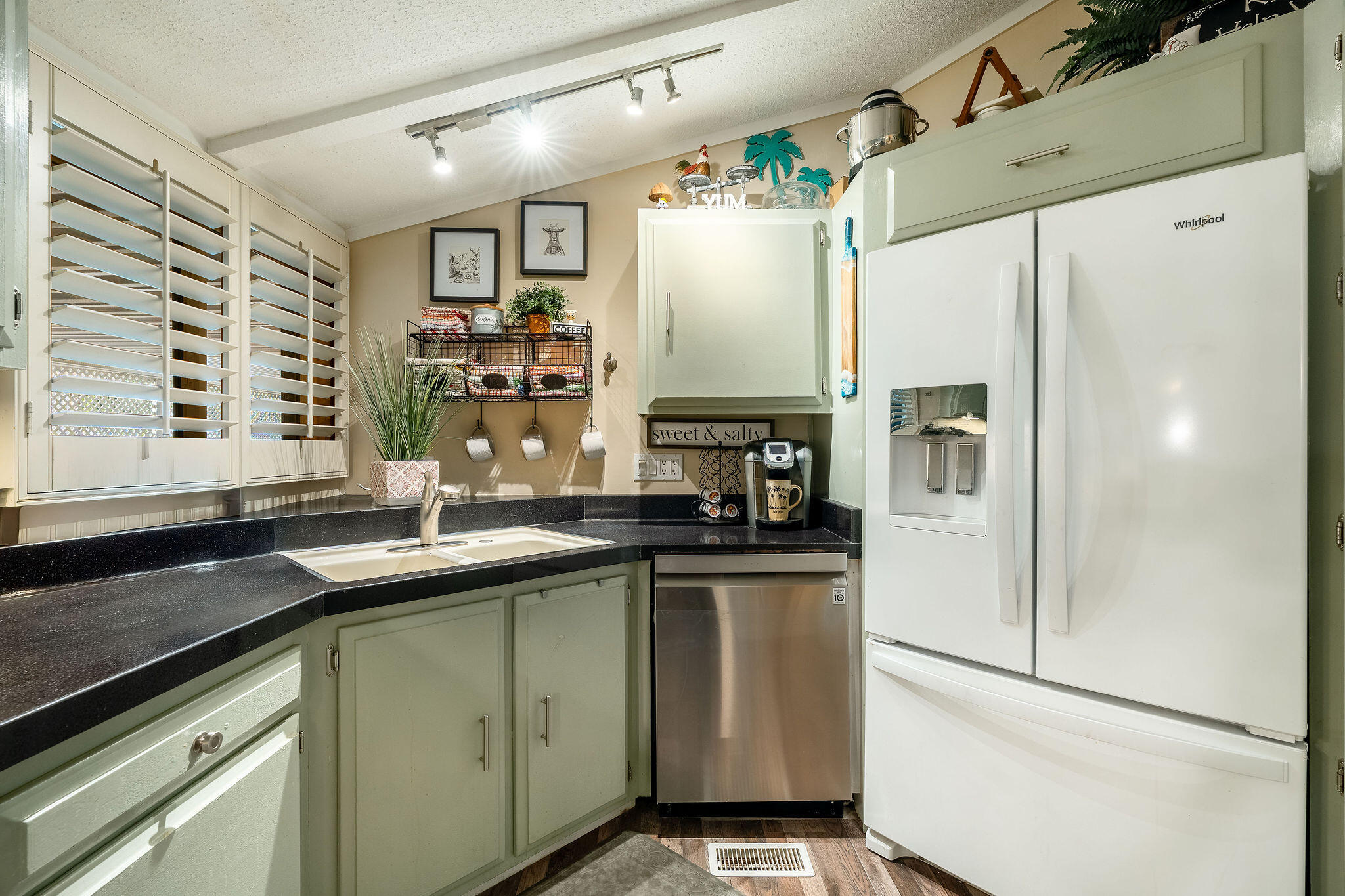 109 International Boulevard Rancho Mirage, CA 92270 - Photo 19 of 64 a kitchen with stainless steel appliances a sink and a refrigerator