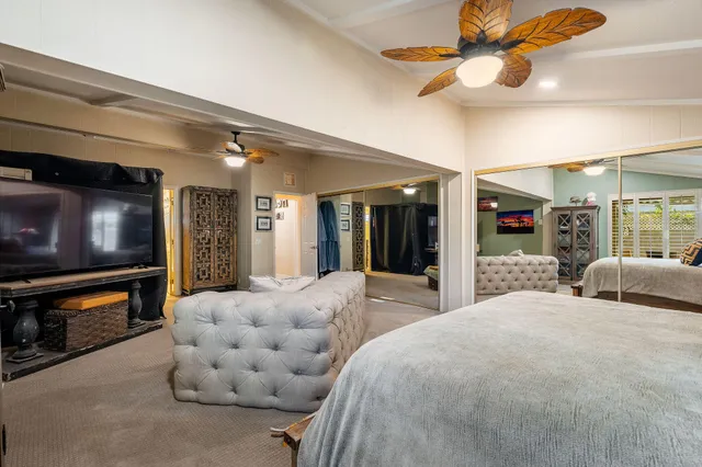 a bathroom with a granite countertop sink a toilet and mirror