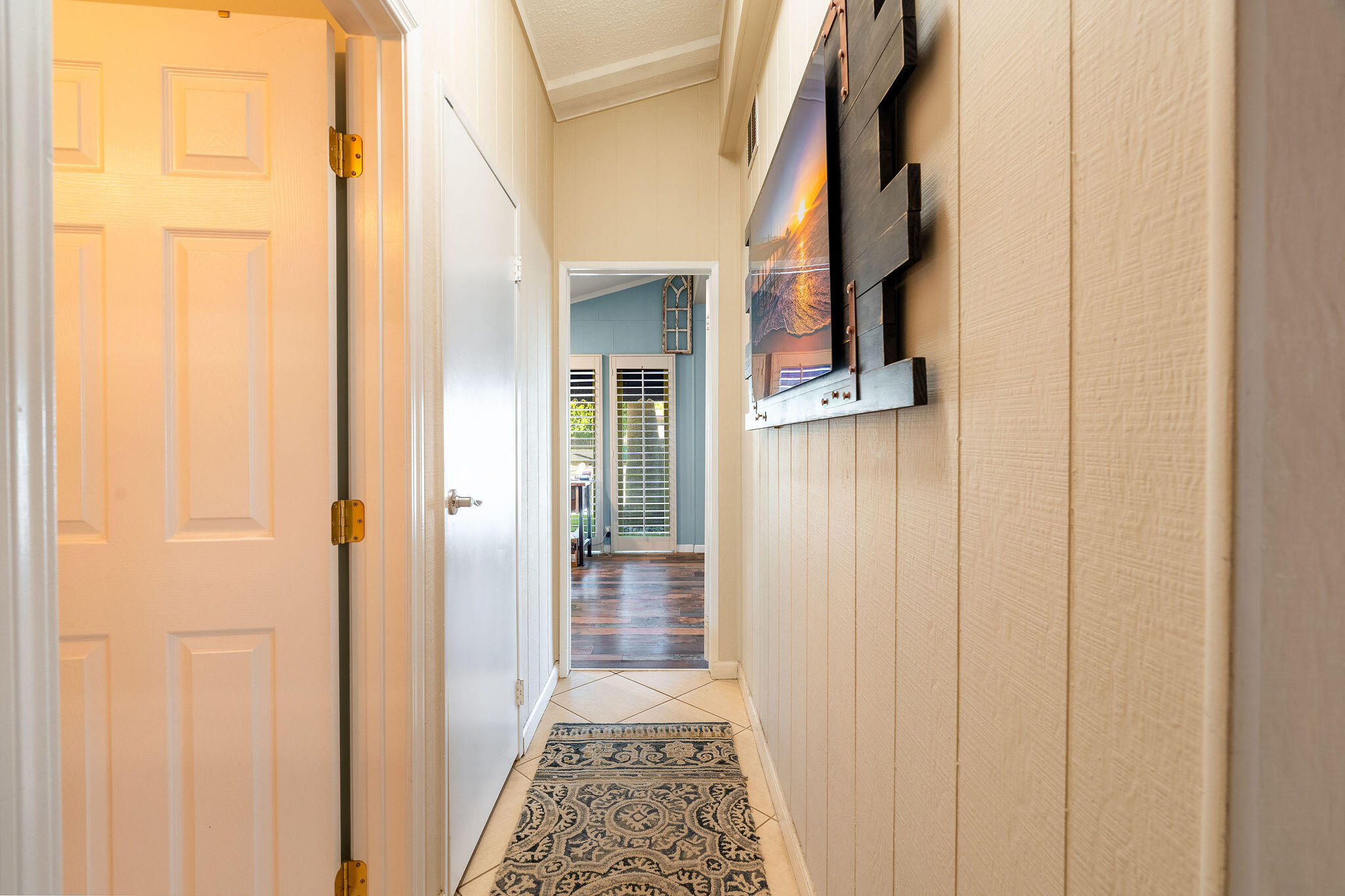 109 International Boulevard Rancho Mirage, CA 92270 - Photo 30 of 64 a view of a hallway with wooden floor and a bathroom