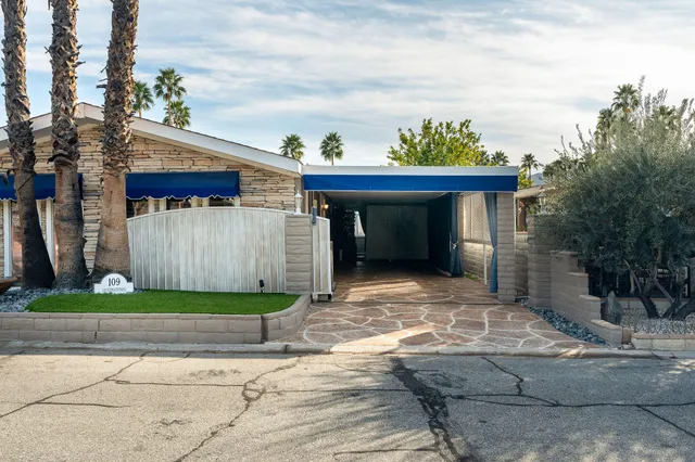 a front view of multiple houses with a yard