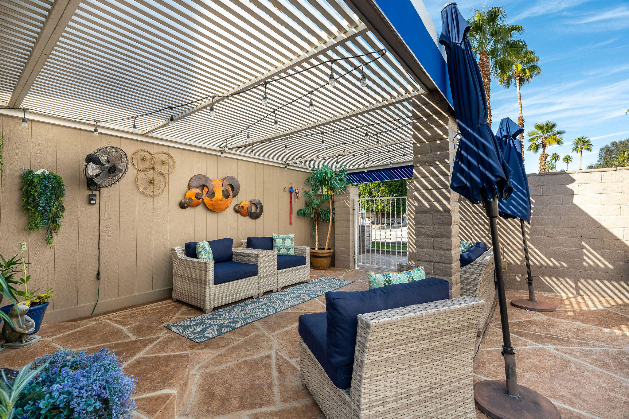 109 International Boulevard Rancho Mirage, CA 92270 - Photo 6 of 64 a outdoor living space with patio furniture and a potted plant