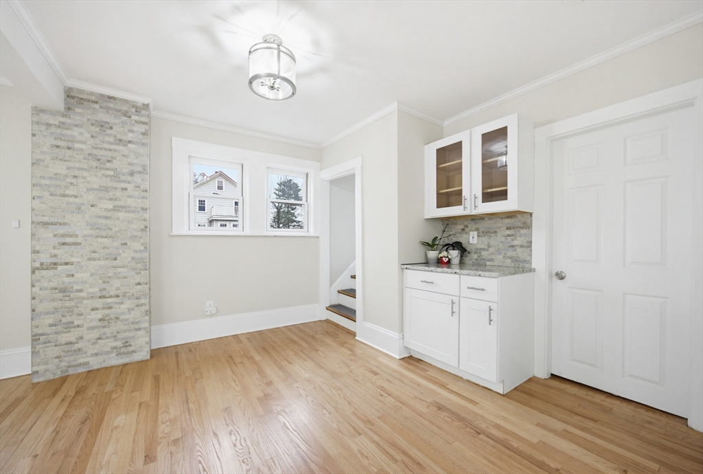 29 Shawmut Terrace Framingham, MA 01702 - Photo 15 of 42 a room with a white cabinets and wooden floor