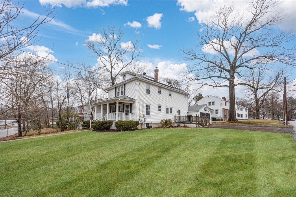29 Shawmut Terrace Framingham, MA 01702 - Photo 2 of 42 a view of a white house in front of a big yard with plants and large trees