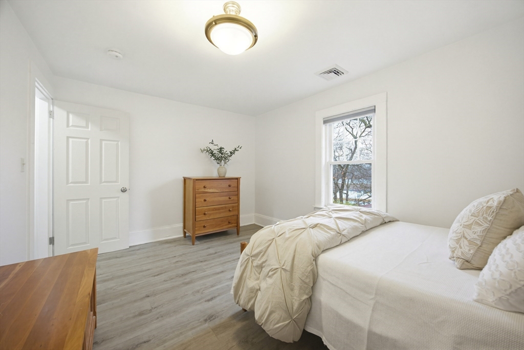 29 Shawmut Terrace Framingham, MA 01702 - Photo 32 of 42 a bedroom with a bed and wooden floor
