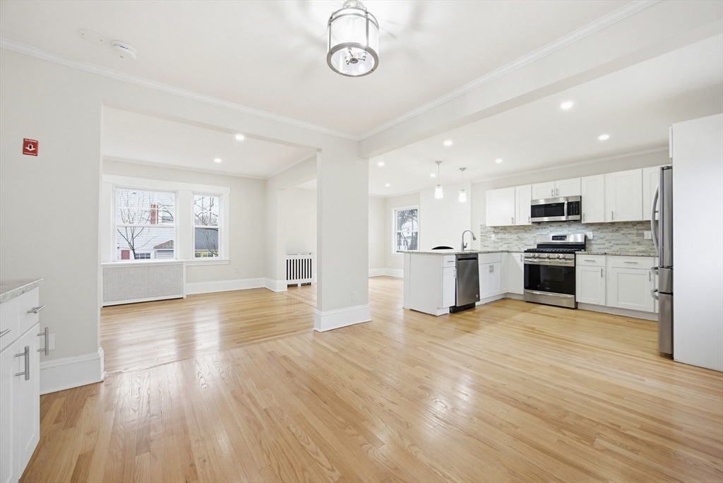 29 Shawmut Terrace Framingham, MA 01702 - Photo 4 of 42 a view of kitchen with microwave a stove and wooden floor