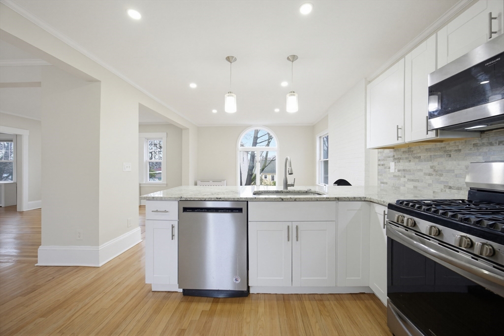 29 Shawmut Terrace Framingham, MA 01702 - Photo 5 of 42 a kitchen with stainless steel appliances a sink stove and cabinets