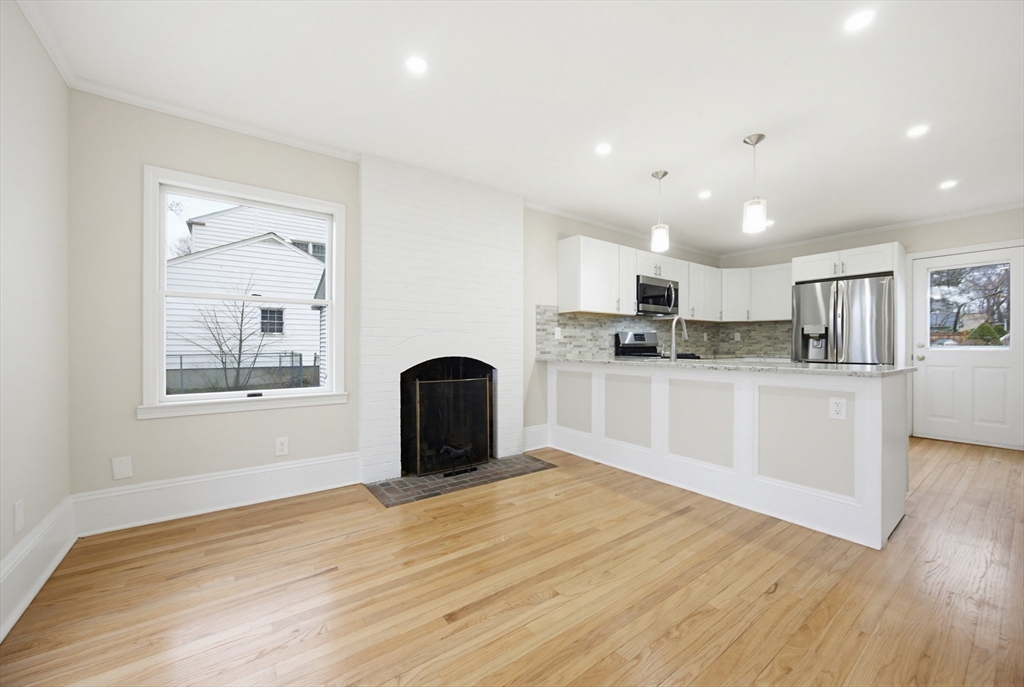 29 Shawmut Terrace Framingham, MA 01702 - Photo 6 of 42 a view of kitchen with stainless steel appliances granite countertop a stove top oven a sink dishwasher and a refrigerator with wooden floor