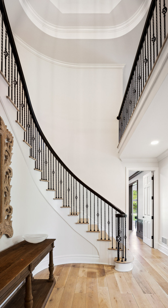 480 Wagner Road Northfield, IL 60093 - Photo 10 of 53 a view of staircase with lots of frames on wall and a window