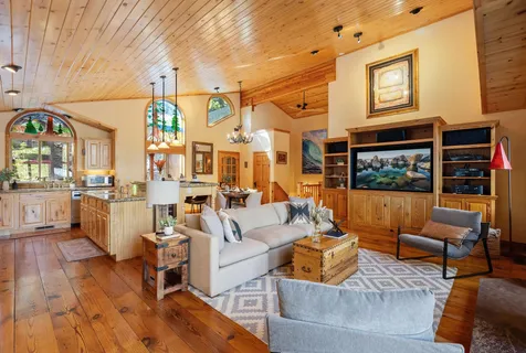 a living room with furniture fireplace and dining table