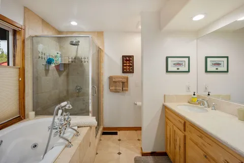 a bathroom with a tub sink and mirror