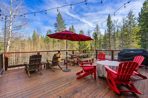 a view of a roof deck with table and chairs under an umbrella