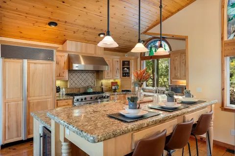 a kitchen with a table chairs and a wooden floor