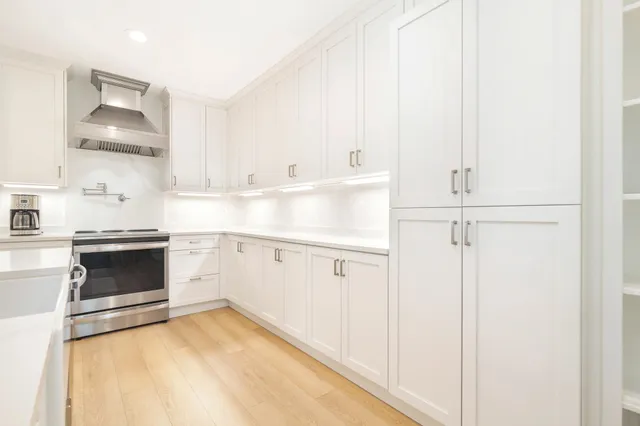 a kitchen with white cabinets and white appliances