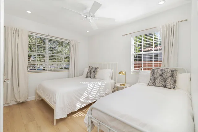 a bedroom with two beds and a window