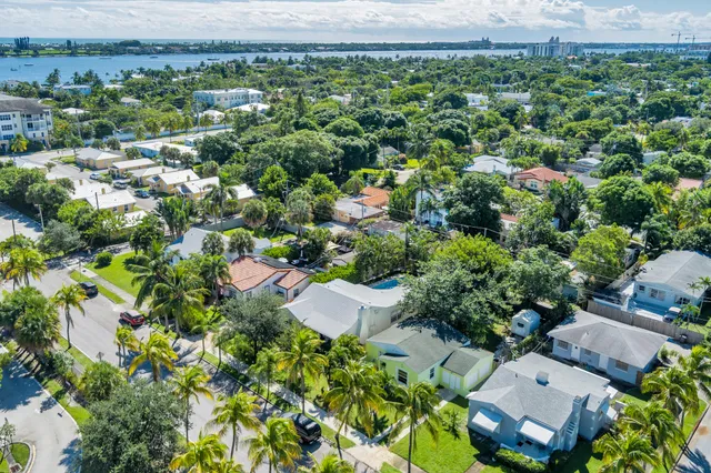 an aerial view of a house with a yard and outdoor seating