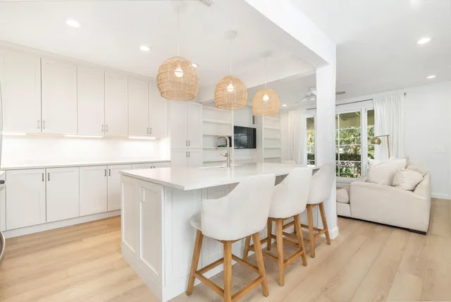 a kitchen with a sink cabinets and wooden floor