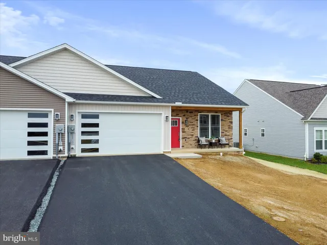 a view of a house with garage and yard