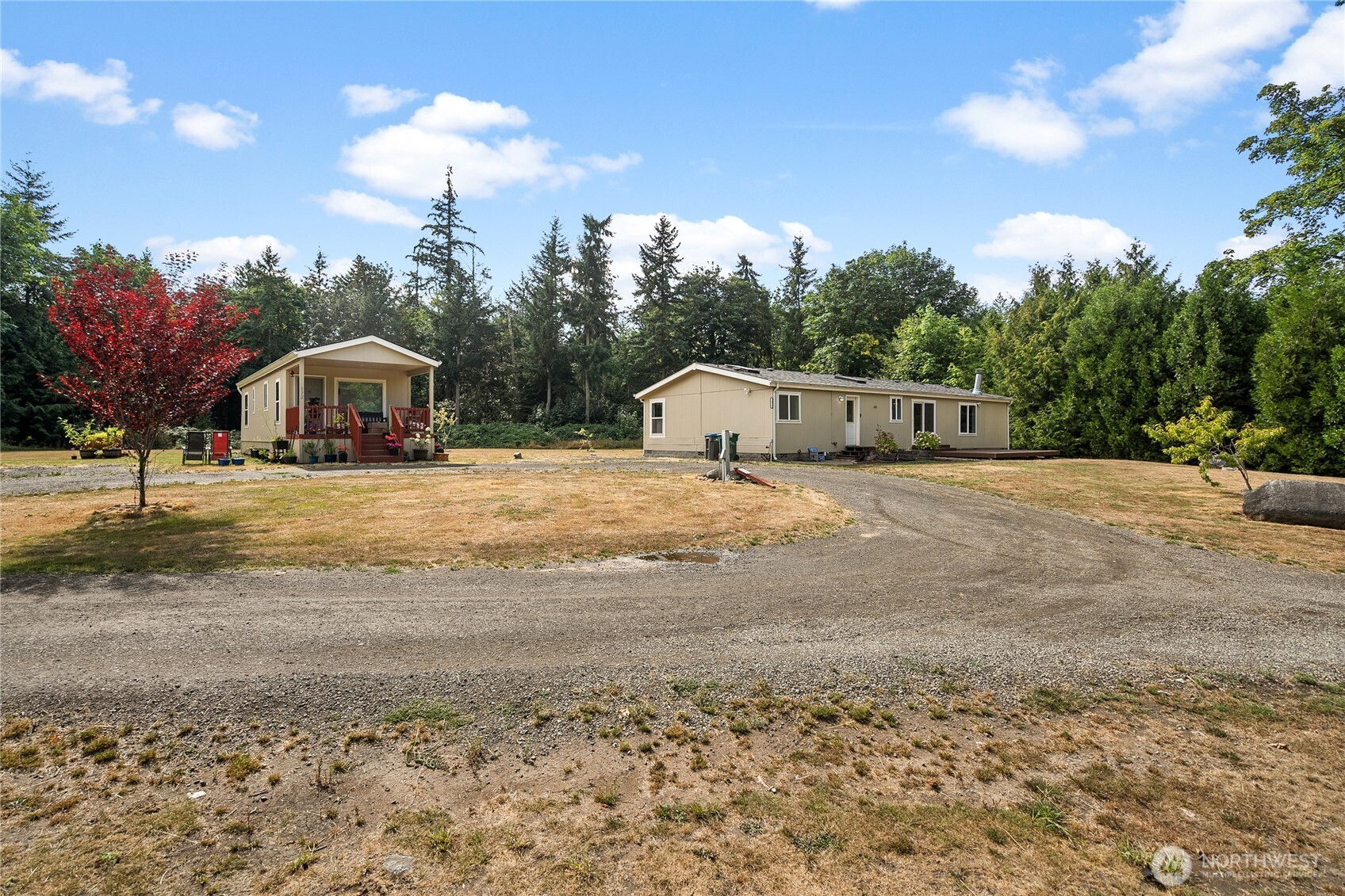 a view of a house with a yard and trees