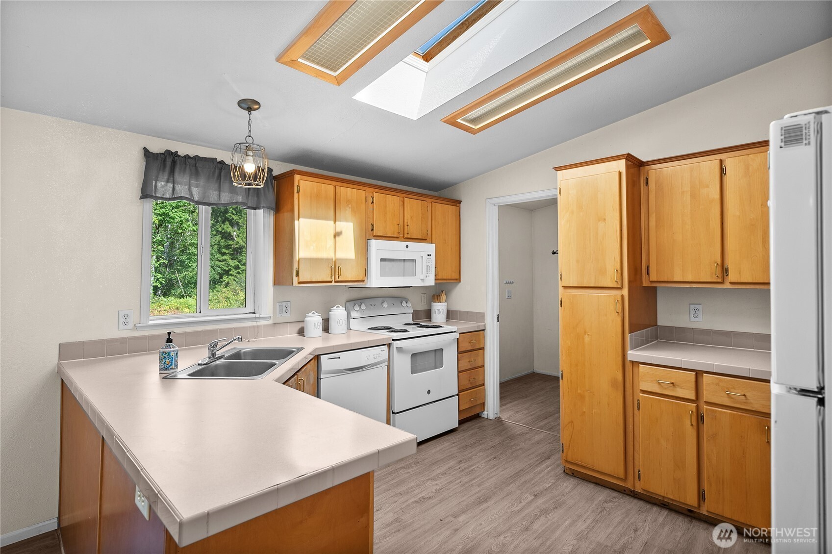 1870 Northwest Vaa Road Poulsbo, WA 98370 - Photo 12 of 40 a kitchen with a stove a sink and a refrigerator