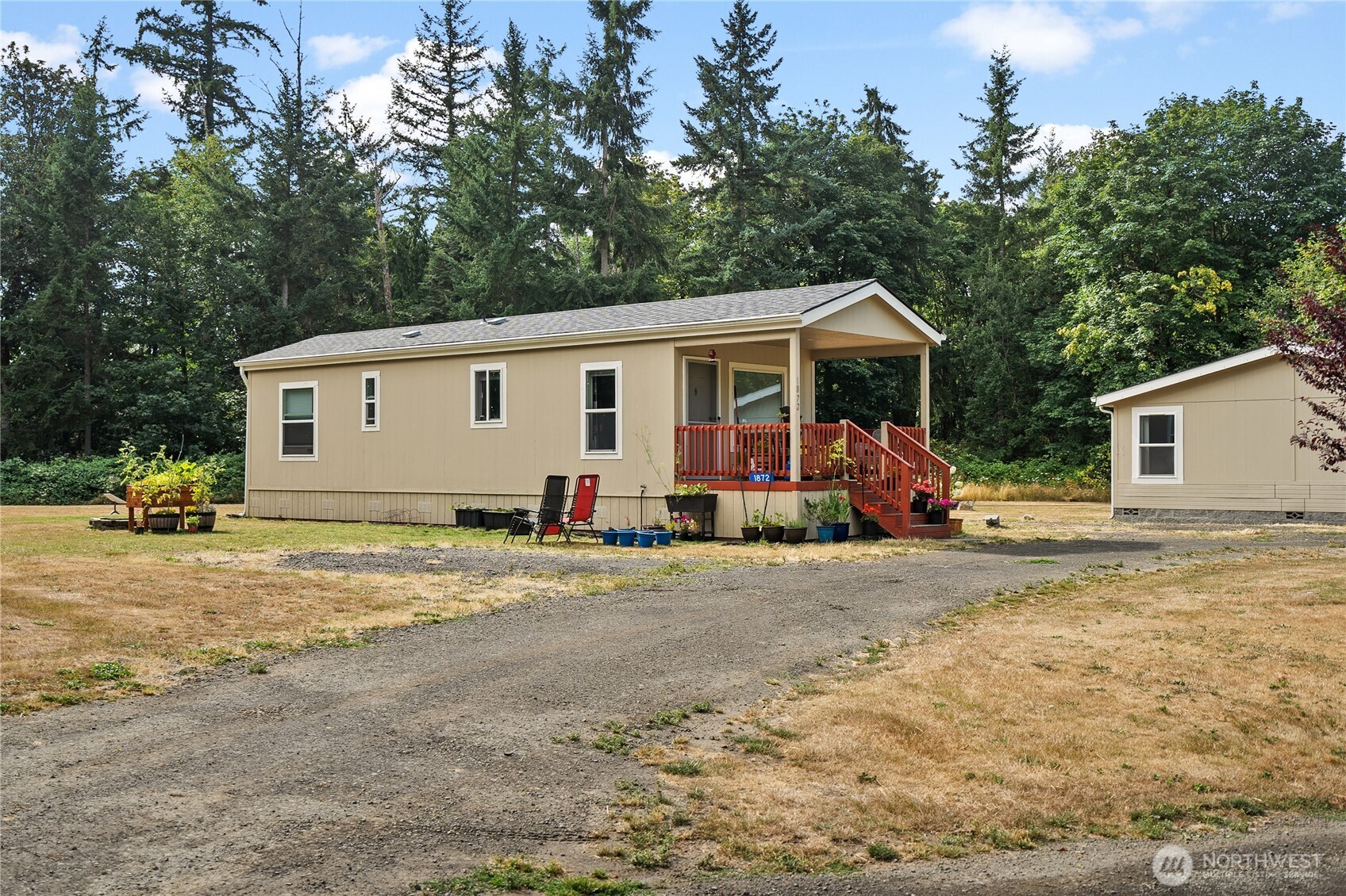 1870 Northwest Vaa Road Poulsbo, WA 98370 - Photo 2 of 40 a view of a house with backyard and trees in the background