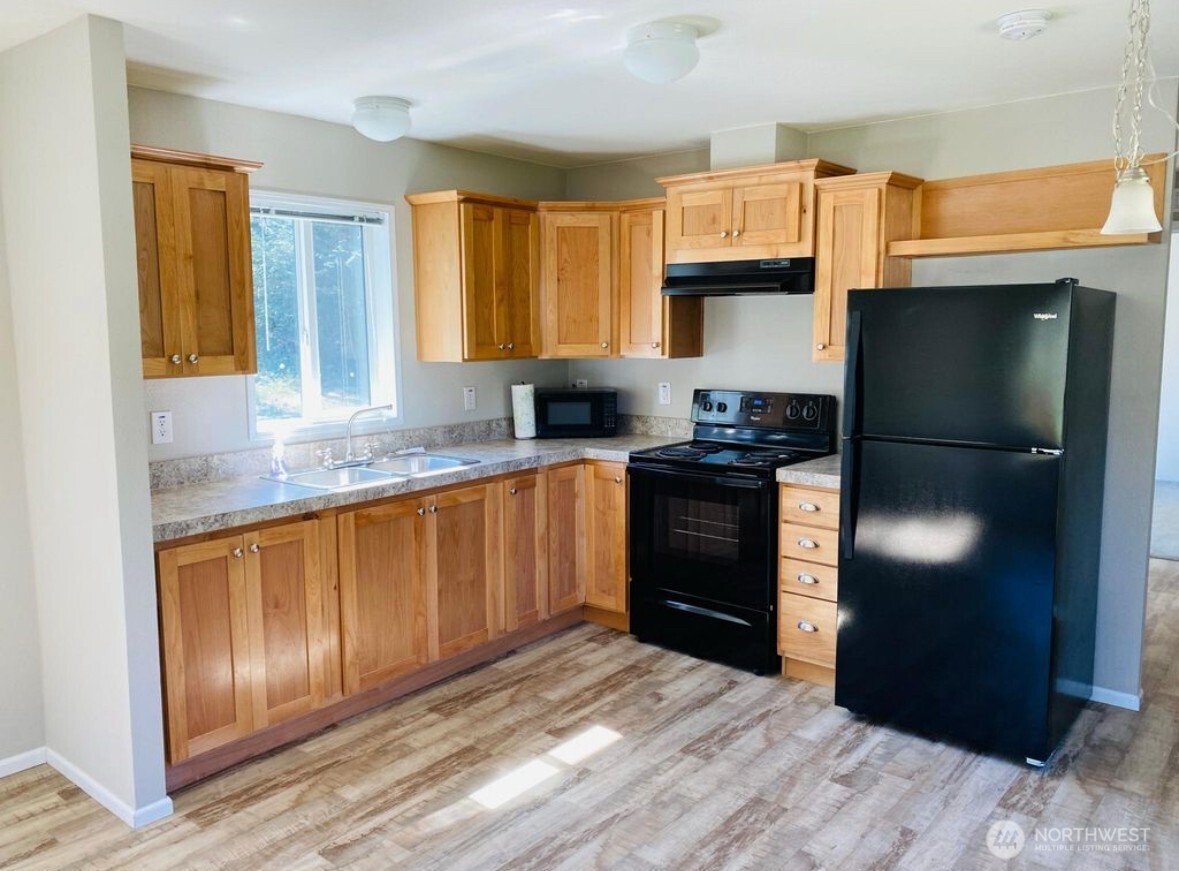 1870 Northwest Vaa Road Poulsbo, WA 98370 - Photo 35 of 40 a kitchen with granite countertop stainless steel appliances and refrigerator