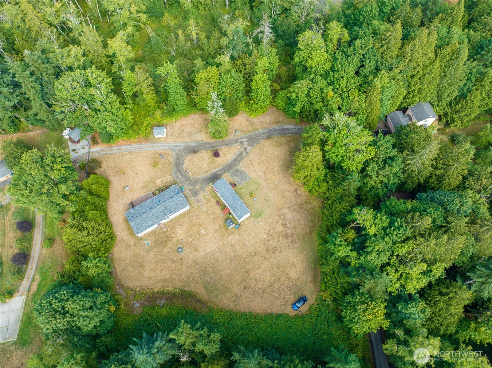 1870 Northwest Vaa Road Poulsbo, WA 98370 - Photo 38 of 40 an aerial view of a house with a yard and trees