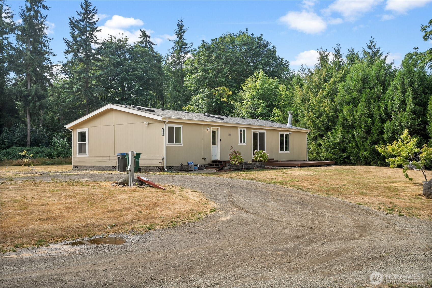1870 Northwest Vaa Road Poulsbo, WA 98370 - Photo 4 of 40 a view of a house with a backyard and trees