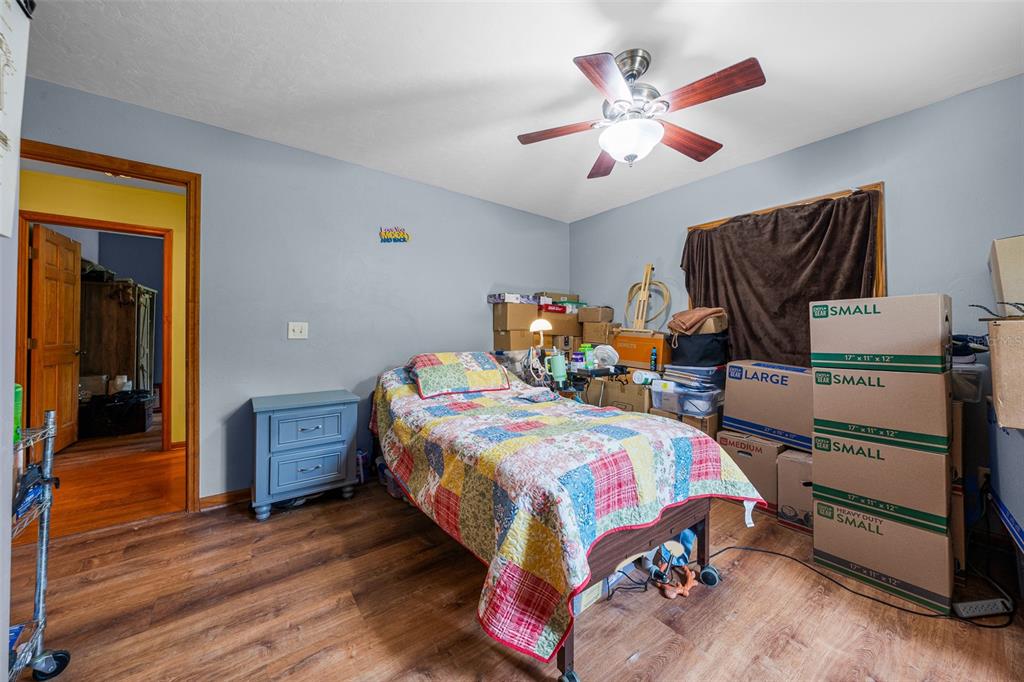 732 Carl Wilson Road Fort White, FL 32038 - Photo 30 of 80 a bedroom with a bed and wooden floor