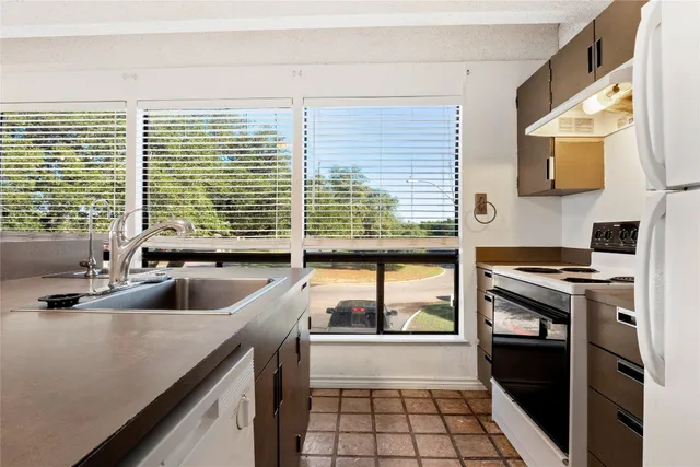 a kitchen with a sink and a stove top oven