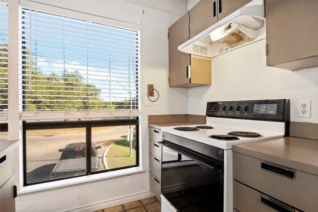 a kitchen with a stove a sink and a microwave