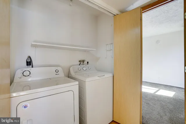 a view of storage and utility room with washer and dryer