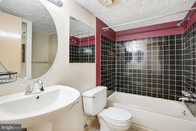 a bathroom with a toilet a sink and bathtub