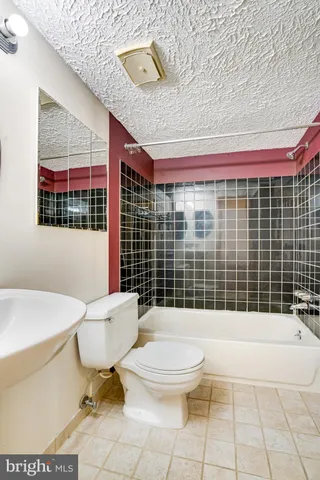 a bathroom with a toilet a sink and shower