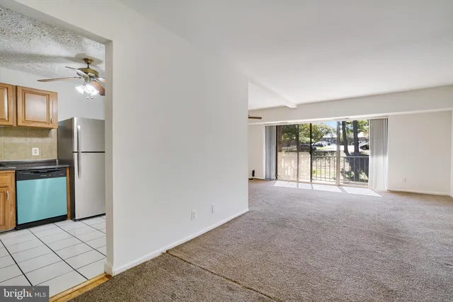 a view of a kitchen with a sink and refrigerator